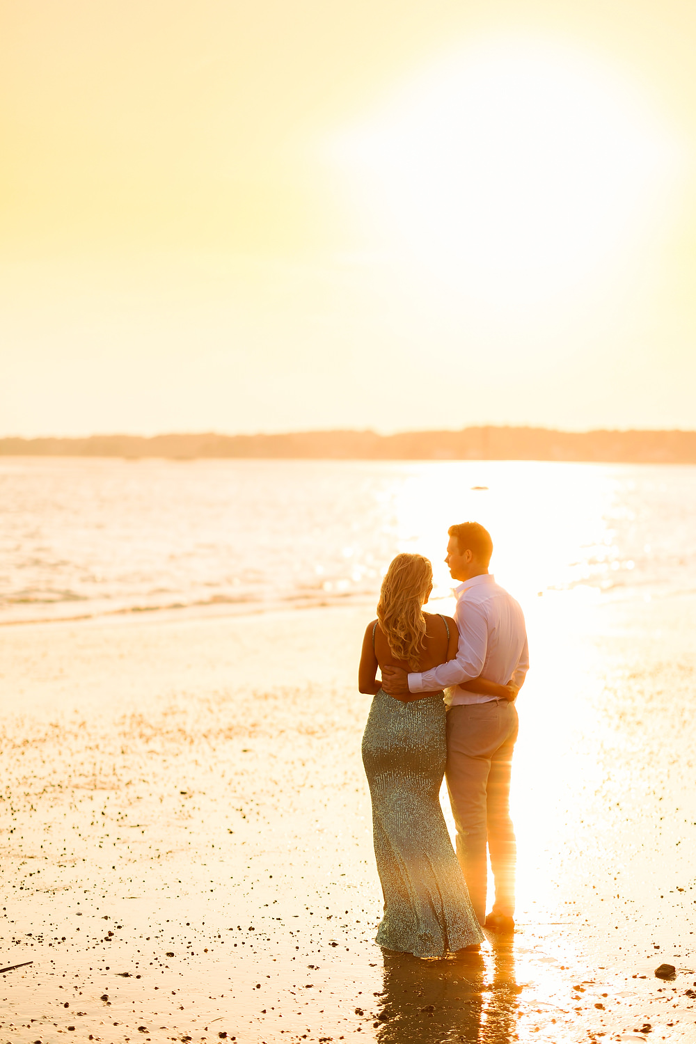 The couple is posing at Duxbury beach for their pictures