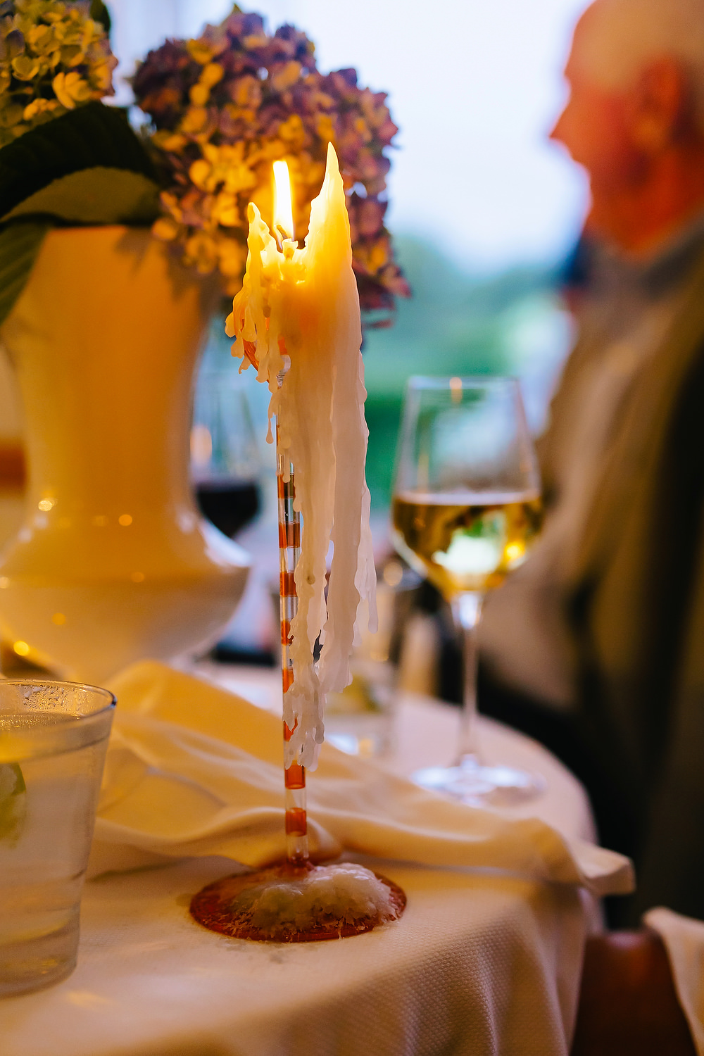 Candlelit tables on terrace before Diana & Luke’s wedding day