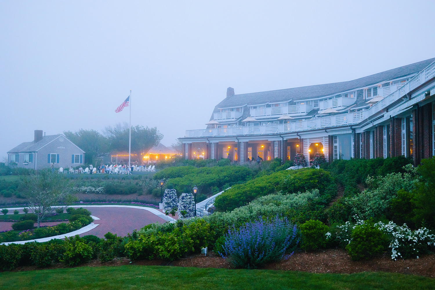 Terrace view of Chatham Bars Inn surrounded by mist at dusk