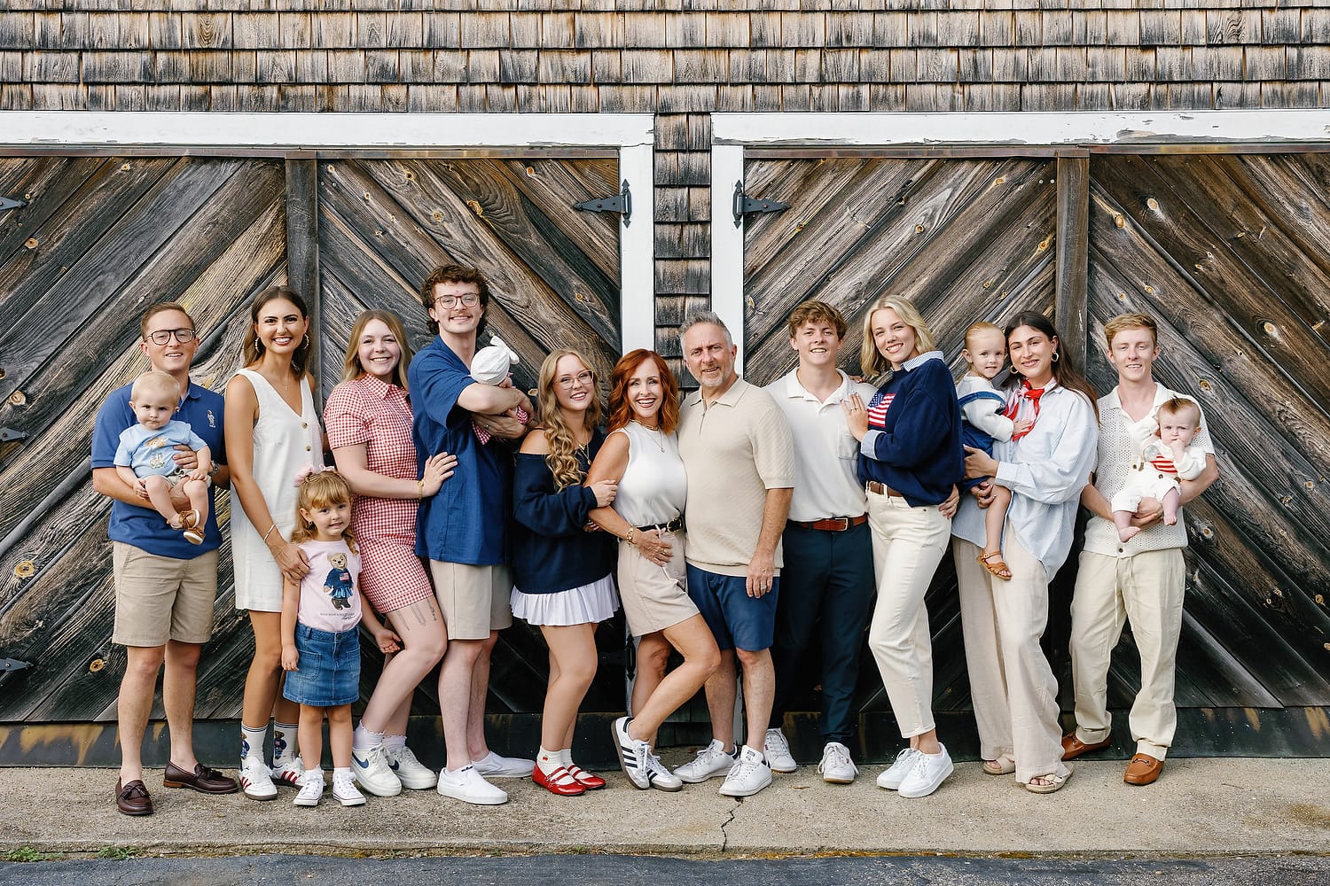 Parents and children laughing together near a quiet Falmouth inlet
