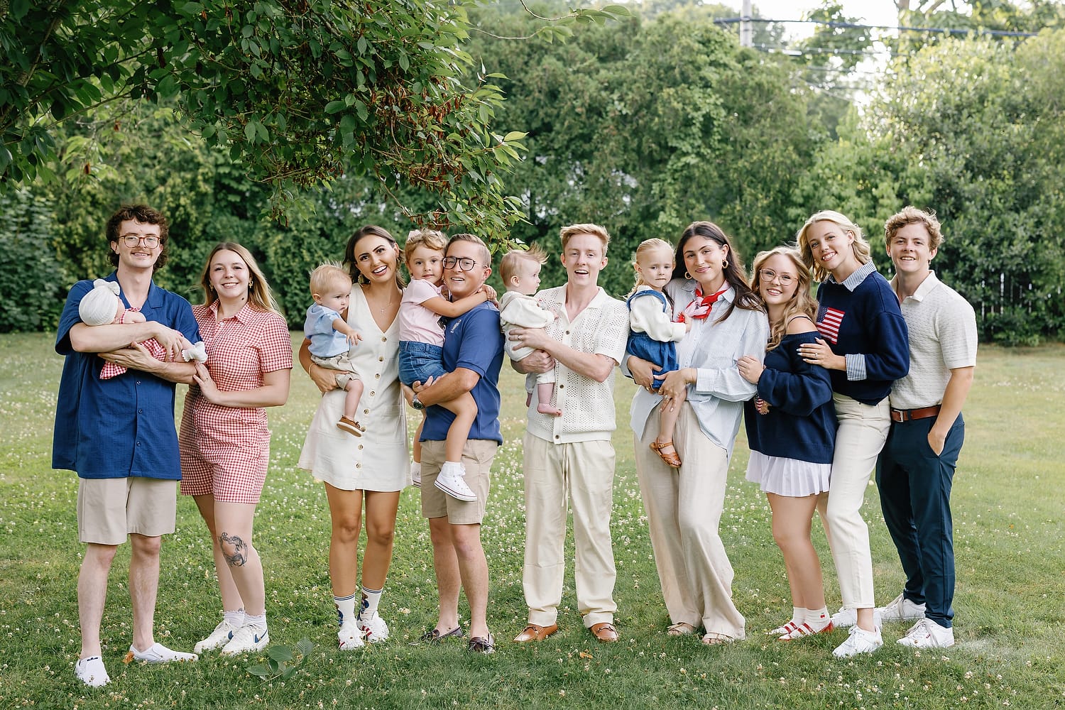 Family walking through coastal grass during Falmouth family photo session