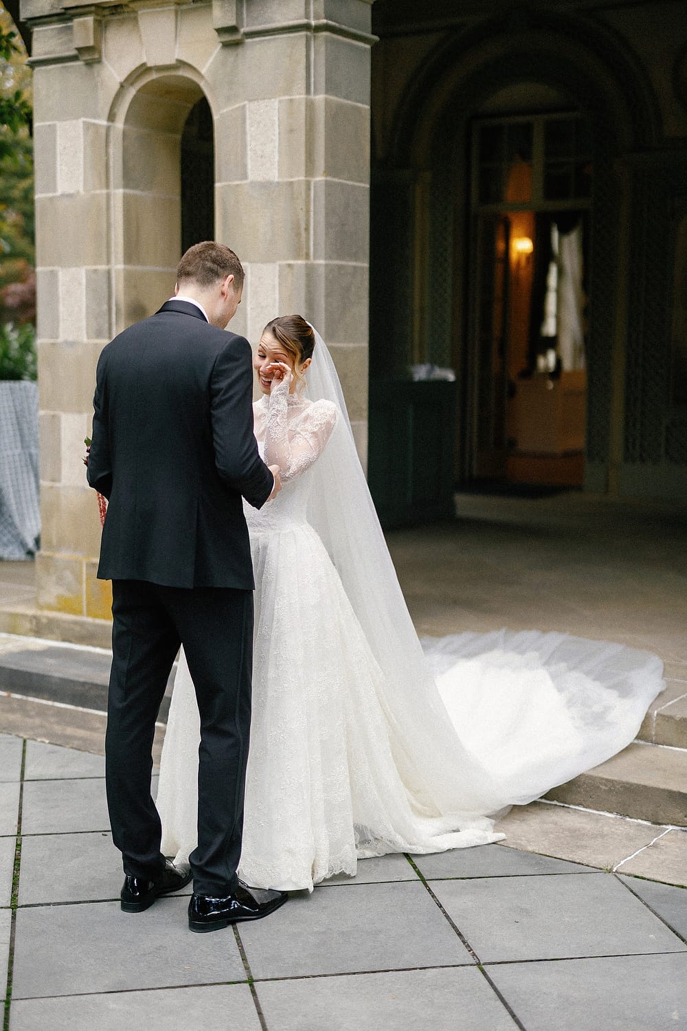 Bride and groom walking along the waterfront terrace at Glen Manor House