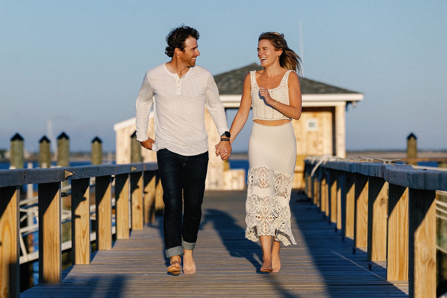 Engagement photos on the dock with rising moon over Hyannis Port harbor